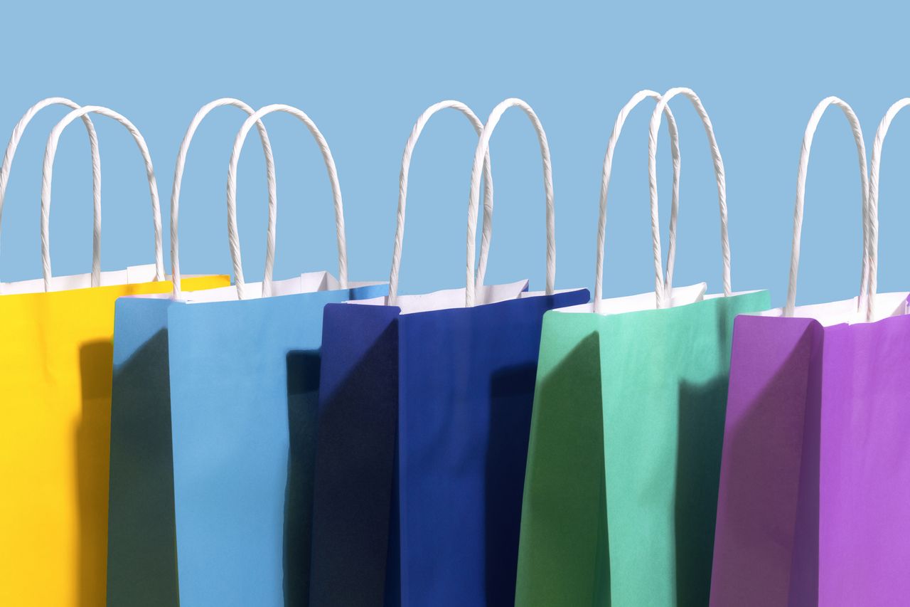 blue, teal and purple shopping bags with light blue background