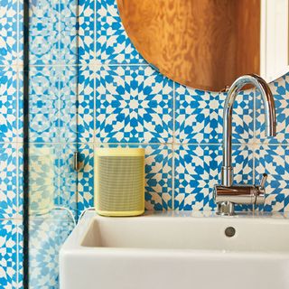 bathroom with blue colour tiles and yellow colour speaker