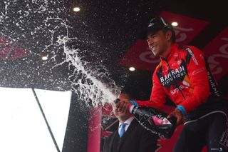 Bahrain Victoriouss Colombian rider Santiago Buitrago sprays sparkling wine as he celebrates on the podium after winning the nineteenth stage of the Giro dItalia 2023 cycling race 183 km between Longarone and Tre Cime di Lavaredo rifugio Auronzo on May 26 2023 Photo by Luca Bettini AFP Photo by LUCA BETTINIAFP via Getty Images