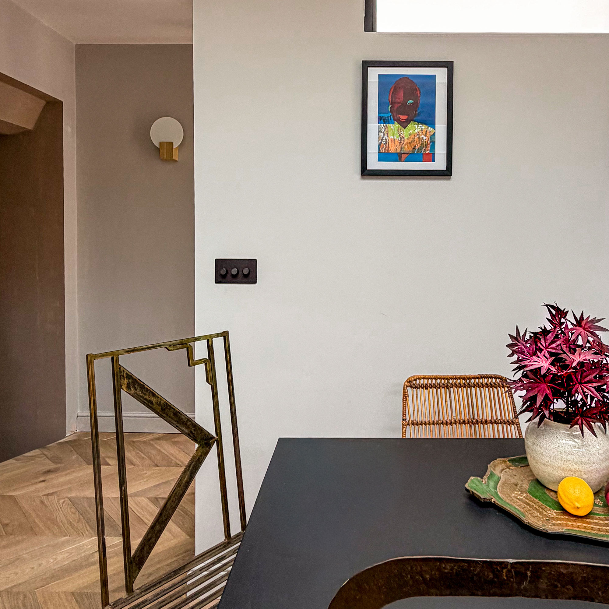 Kitchen table with two mismatched chairs. In room with wooden chevron flooring