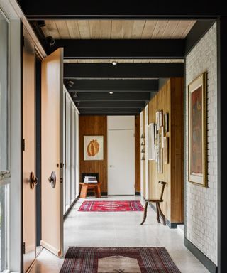 Mid-century modern entryway with wooden framing and eye-catching patterned rugs