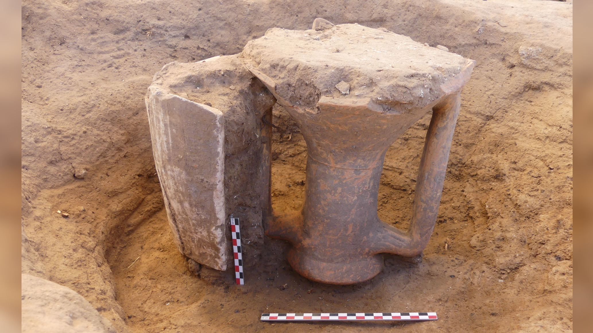 two pottery vessel necks in the ground