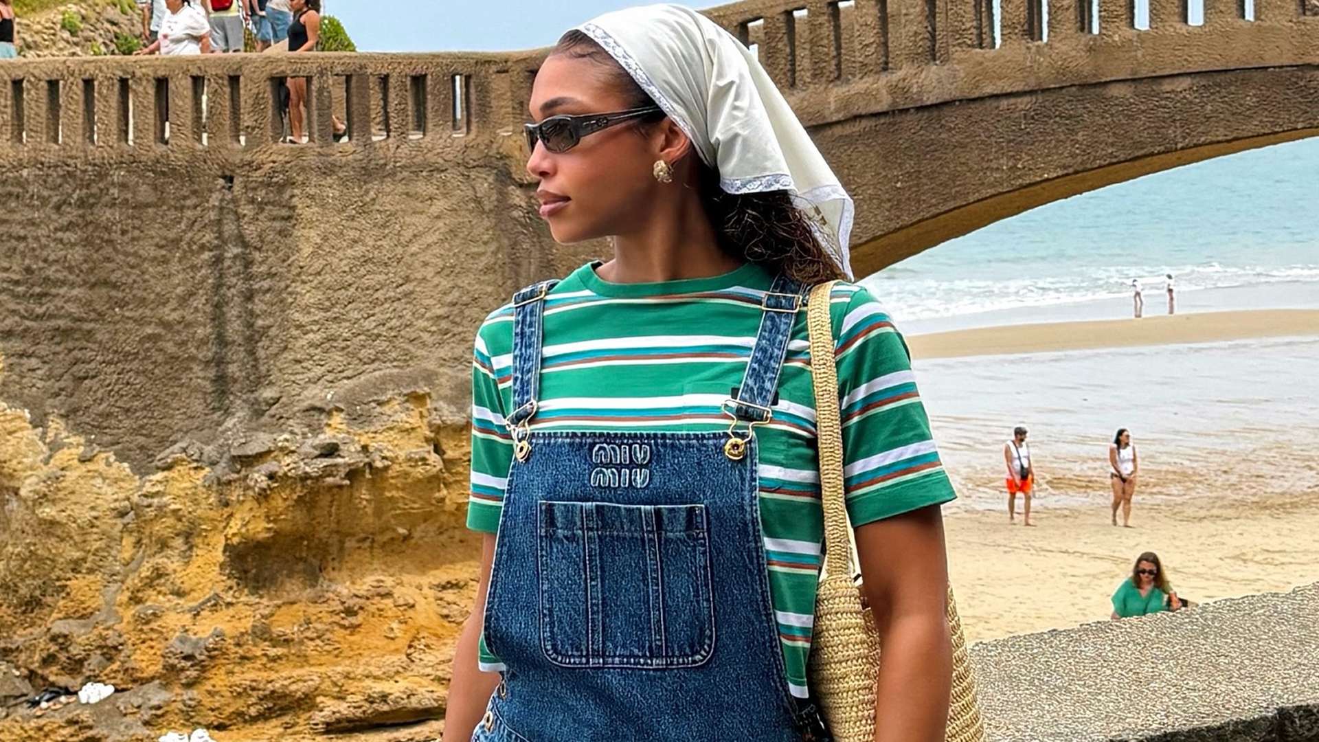 Lori Harvey styled the summer stripes trend with Miu Miu overalls and flip-flops on vacation