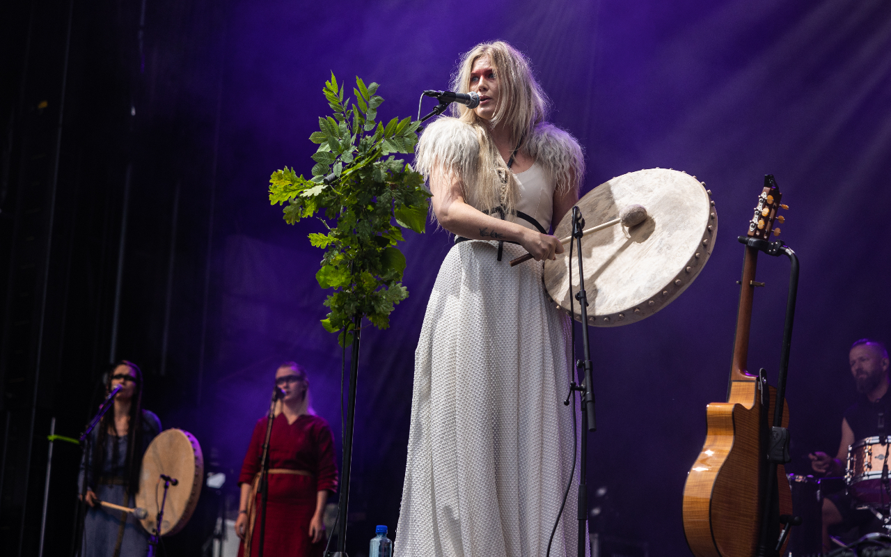 Myrkur live on stage with a drum