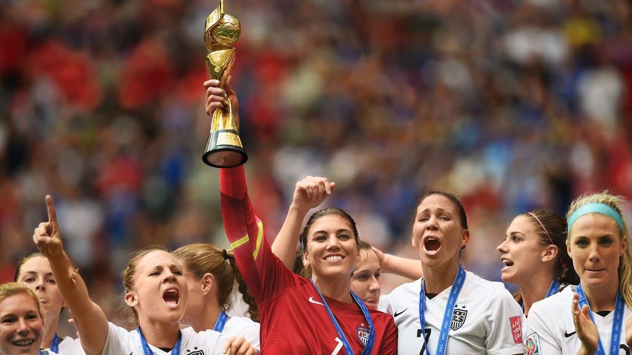 Women&#039;s Soccer team holding up trophy