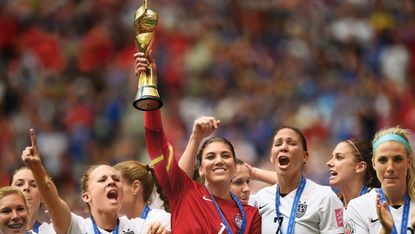 Women's Soccer team holding up trophy