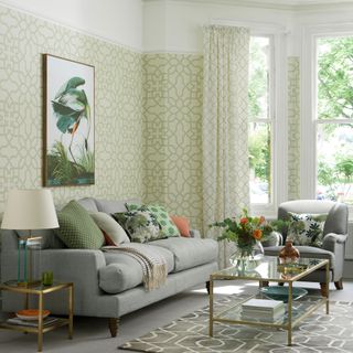 Living room with green and white patterned wallpaper and matching curtains