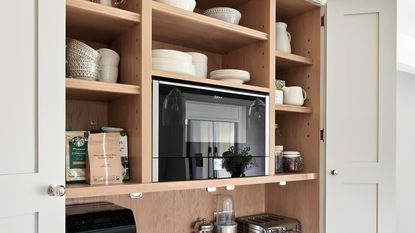 A built-in microwave in an appliance garage