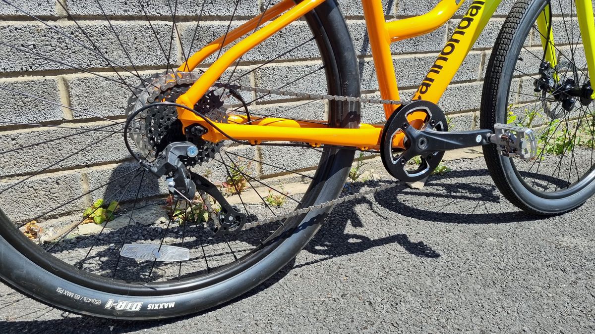 A shot of the full drivetrain on a yellow and orange bike