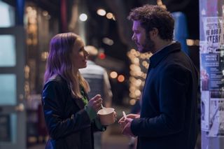 Kristen Bell as Joanne and Adam Brody as Noah, holding cups of ice cream while standing on a city sidewalk, in episode 102 of Nobody Wants This.