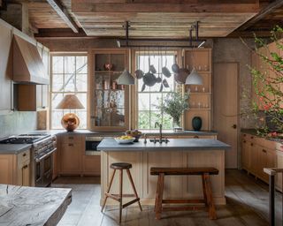 kitchen with wooden Shaker cabinets and an island with a steel gantry above and glazed concrete worksurfaces in19th century four storey West Village townhouse in 19th century four storey West Village townhouse