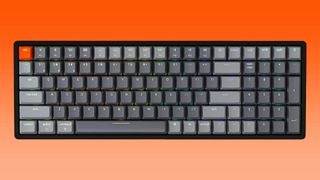 Keychron K4 keyboard against orange gradient background