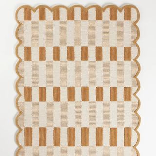 Anthropologie checkered rug with scallop border