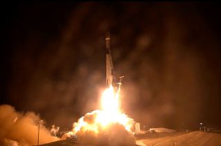 a rocket lifts off into the night sky