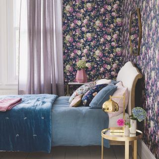 Bedroom with purple floral wallpaper, purple voile curtains and blue bedding