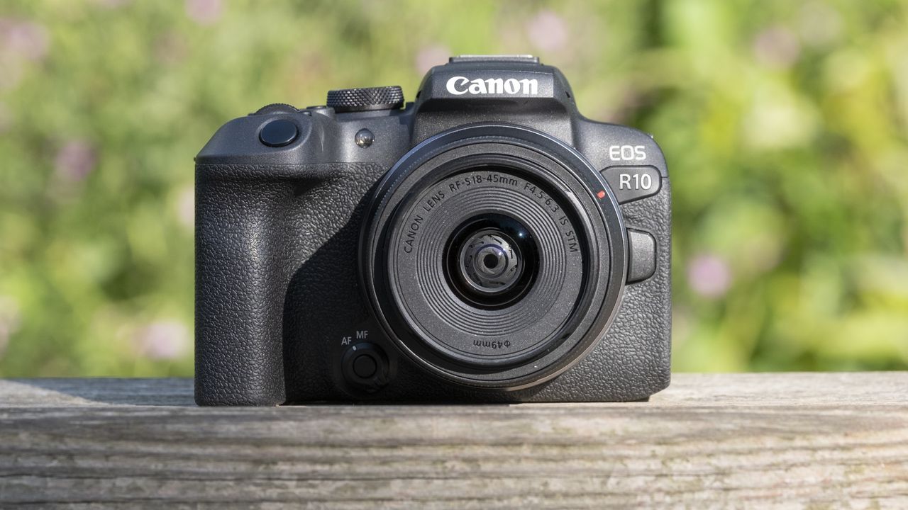 The Canon EOS R10 camera on a wooden shelf