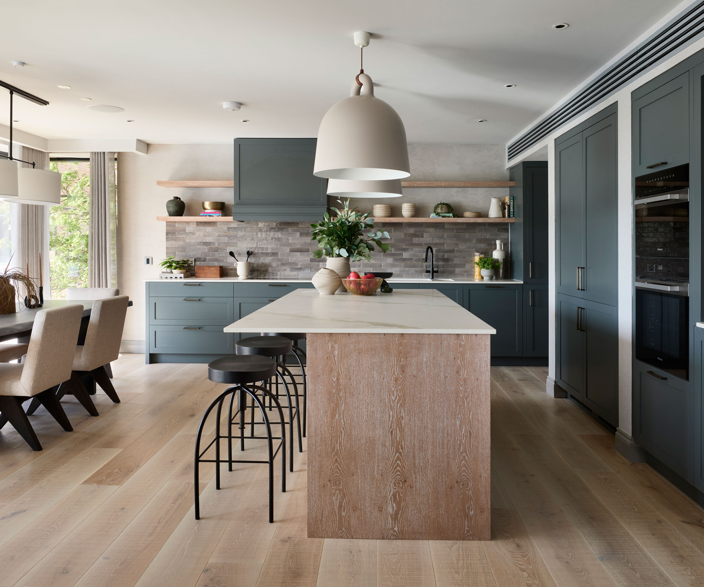 open-plan kitchen diner with large kitchen island with low pendant lighting over