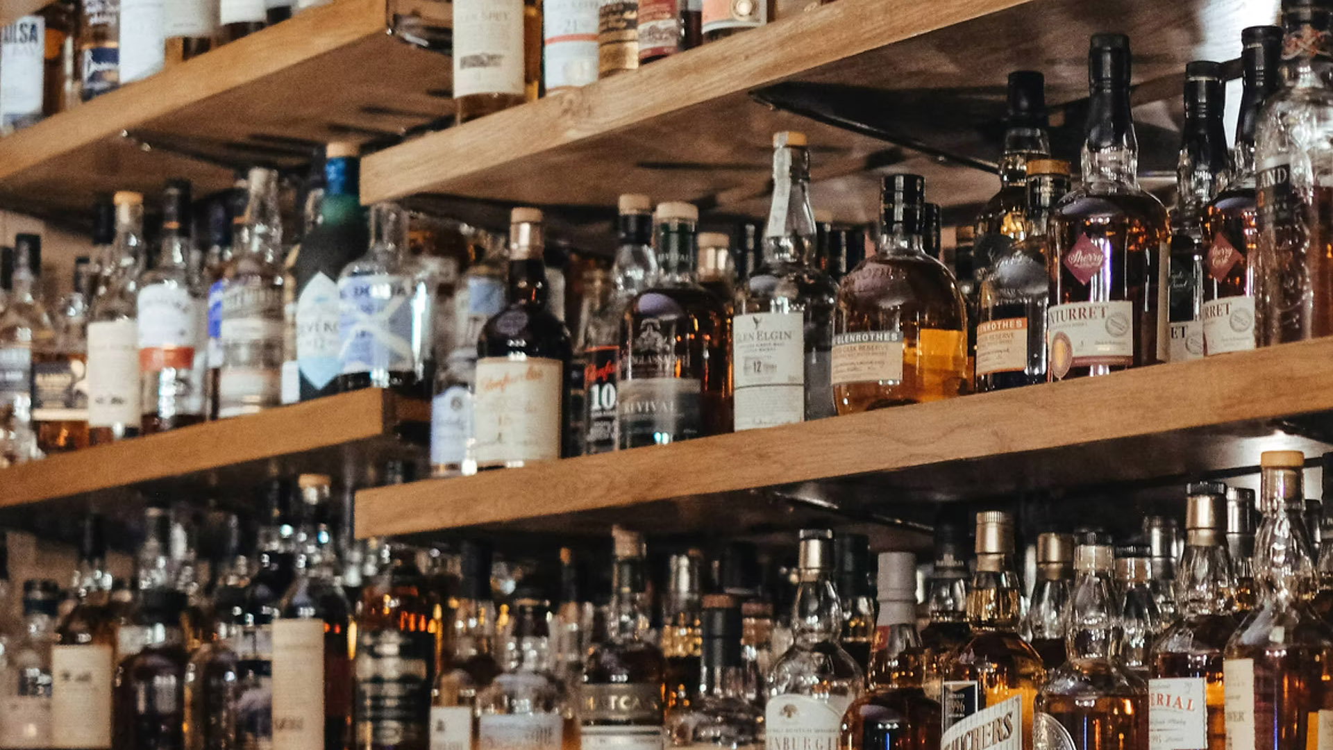 A photo of whisky bottles on a shelf. 