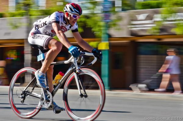 Team Red Truck Racing's Boris Martin flashes past a seemingly oblivious dog walker during Saturday's Men's Criterium.