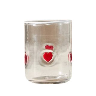 A glass with red heart decorations on it