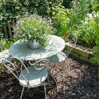 bistro table and chairs in garden