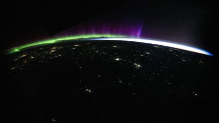 Northern Lights as seen from the ISS with a wide-angle lens showing the curvature of the earth