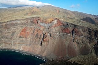 Two monogenetic volcanic cones intersected by a cliff at the western point of El Hierro volcano in the Canary Islands, Spain.