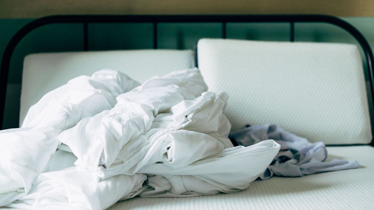 A mattress stripped of bedding before washing cover