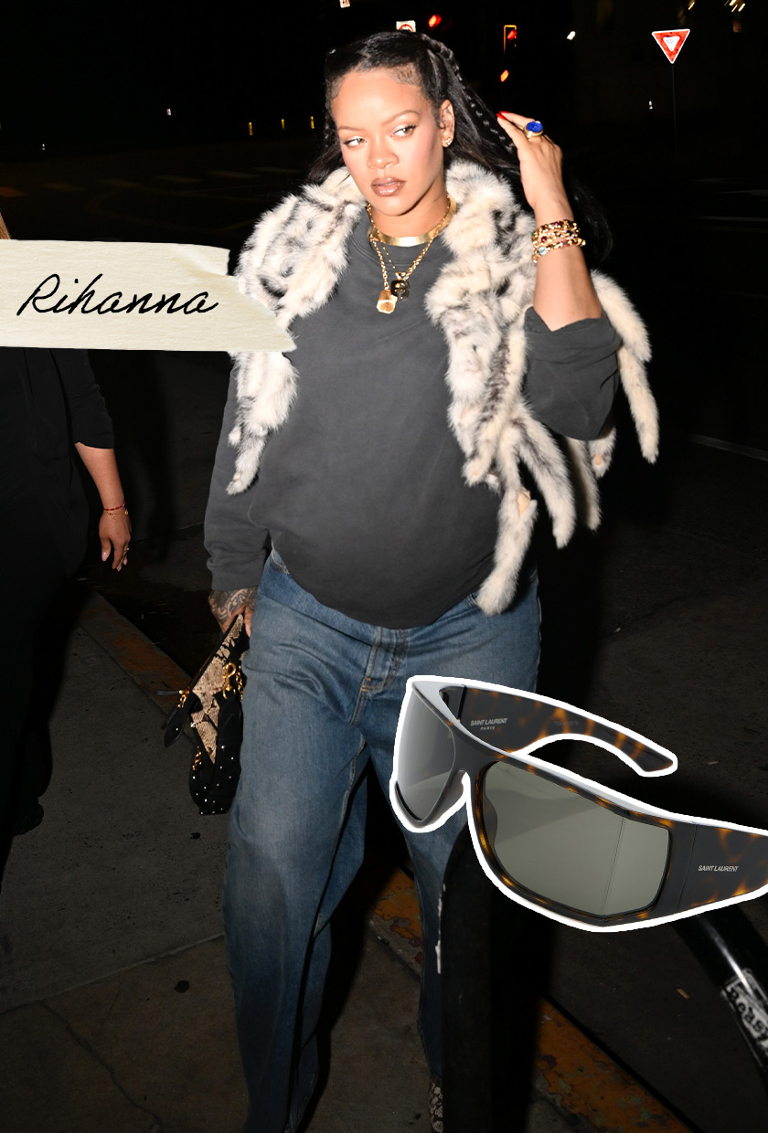 Rihanna wearing a fur vest, a gray crewneck, and dark jeans.