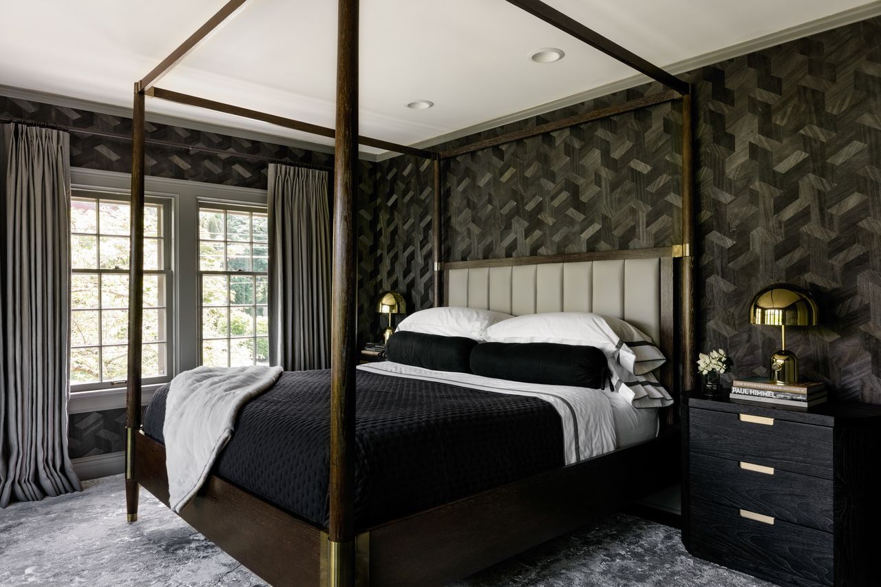 a dark bedroom with wallpaper