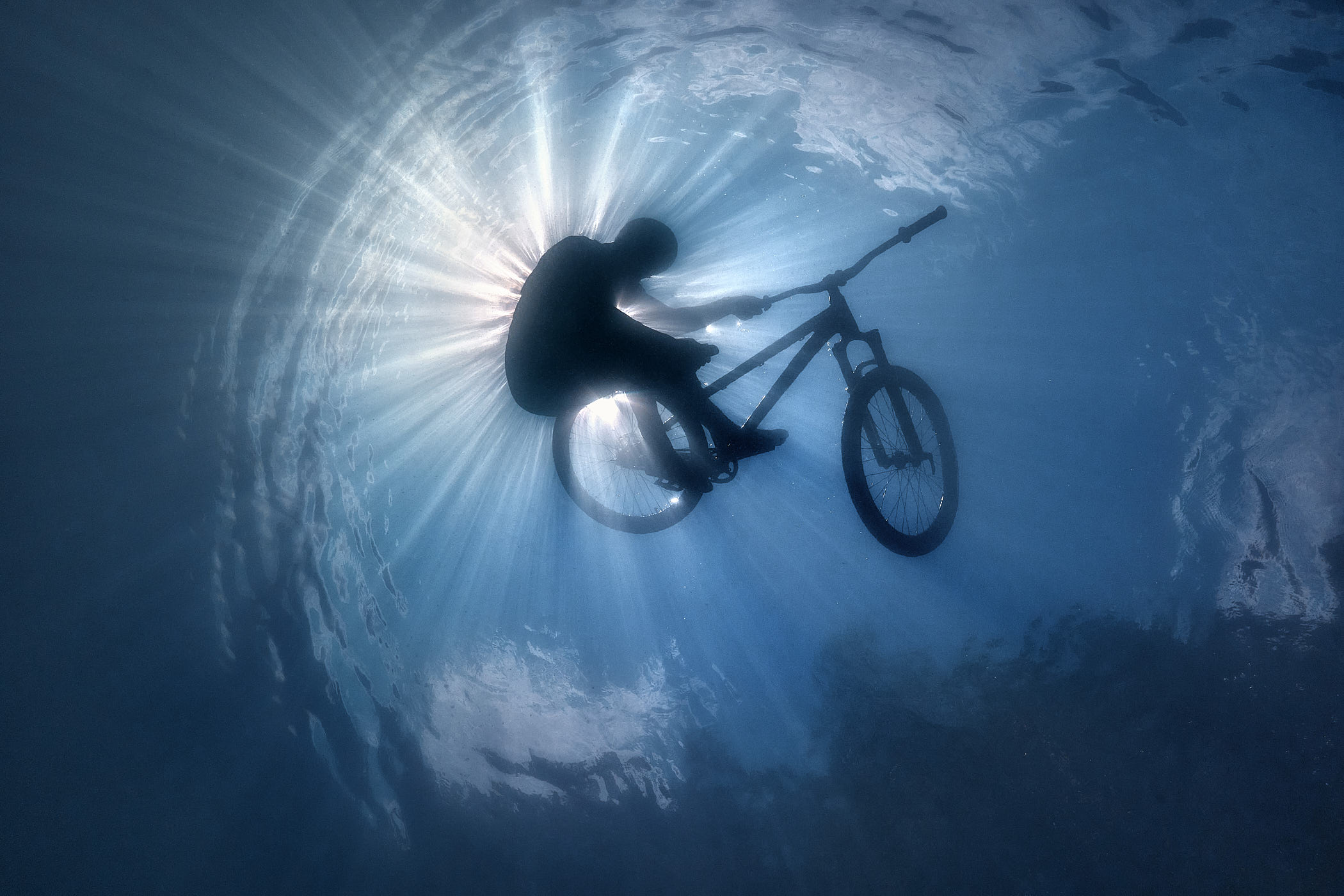 A photograph by Volodya Voronin of a BMX rider submerged in water