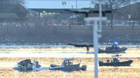 Part of the wreckage is seen as rescue boats search the waters of the Potomac River