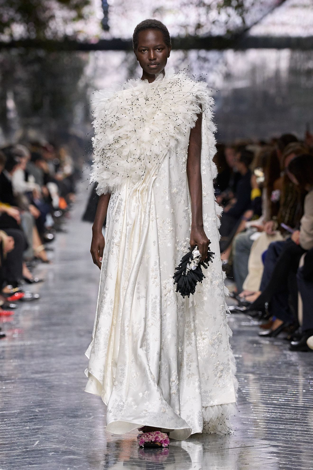 a woman wears a white gown for dior couture show.