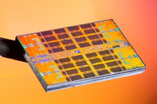 A close-up image of an AMD Zen 2 CCD chiplet, against an orange background, taken by Fritzchens Fritz