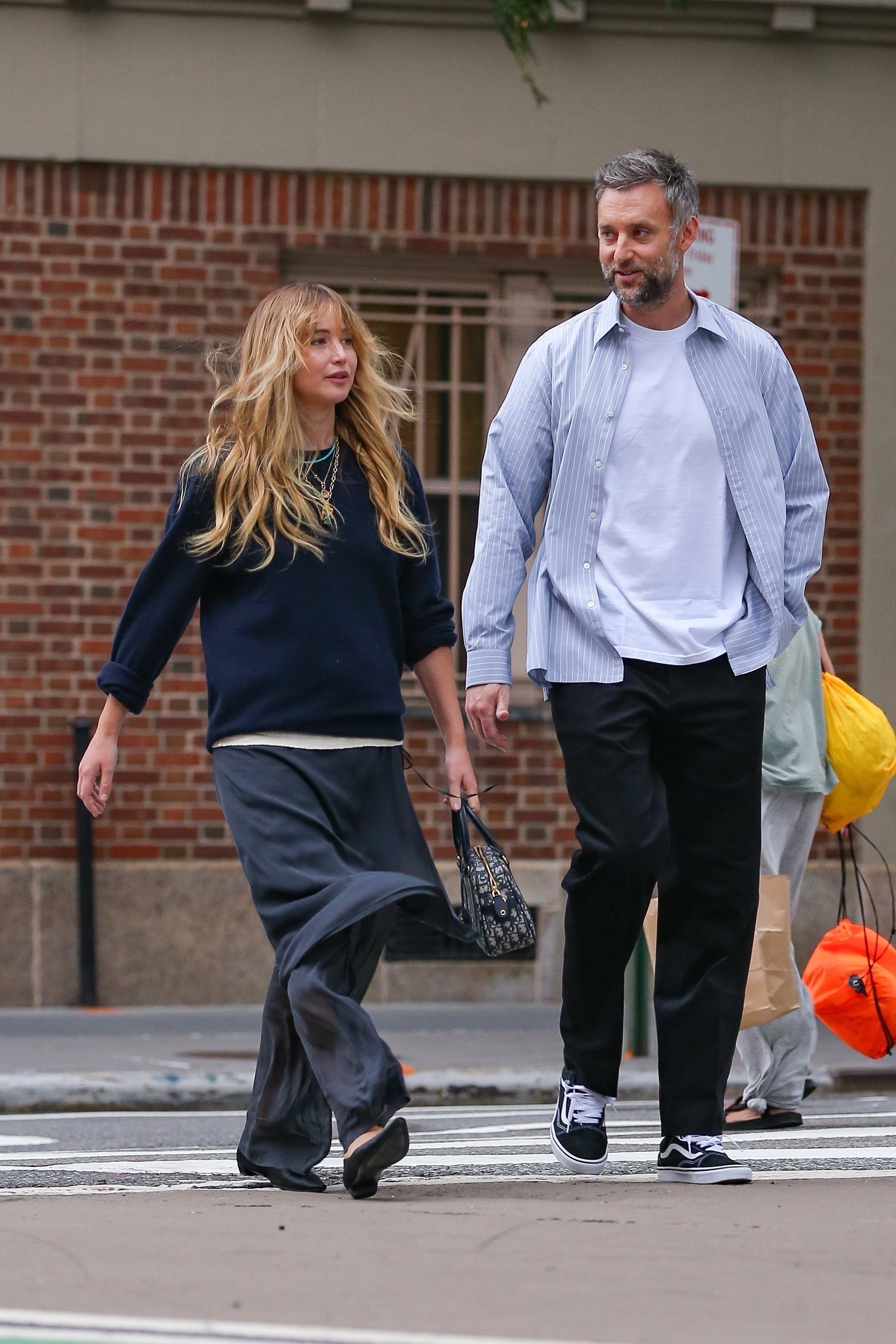 Jennifer Lawrence styled a navy sweater with her favorite skirt-pants and a Dior bowling bag