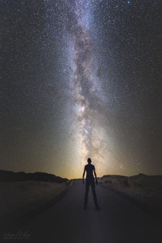 A skywatcher gazes up at the Milky Way from Zabriskie Point in California's Death Valley National Park in this single-exposure shot by astrophotographer Miguel Claro.