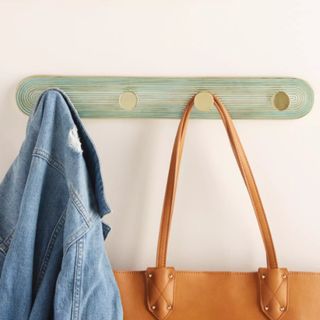 the anthropologie ruth hook rack, a hanging set of four pegs for coats and bags in mint