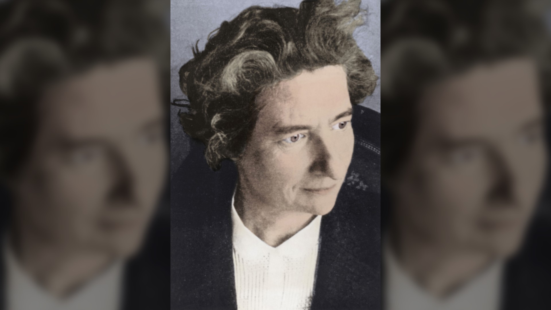 A black and white photo of French nuclear chemist Marguerite Perey that has had color added.