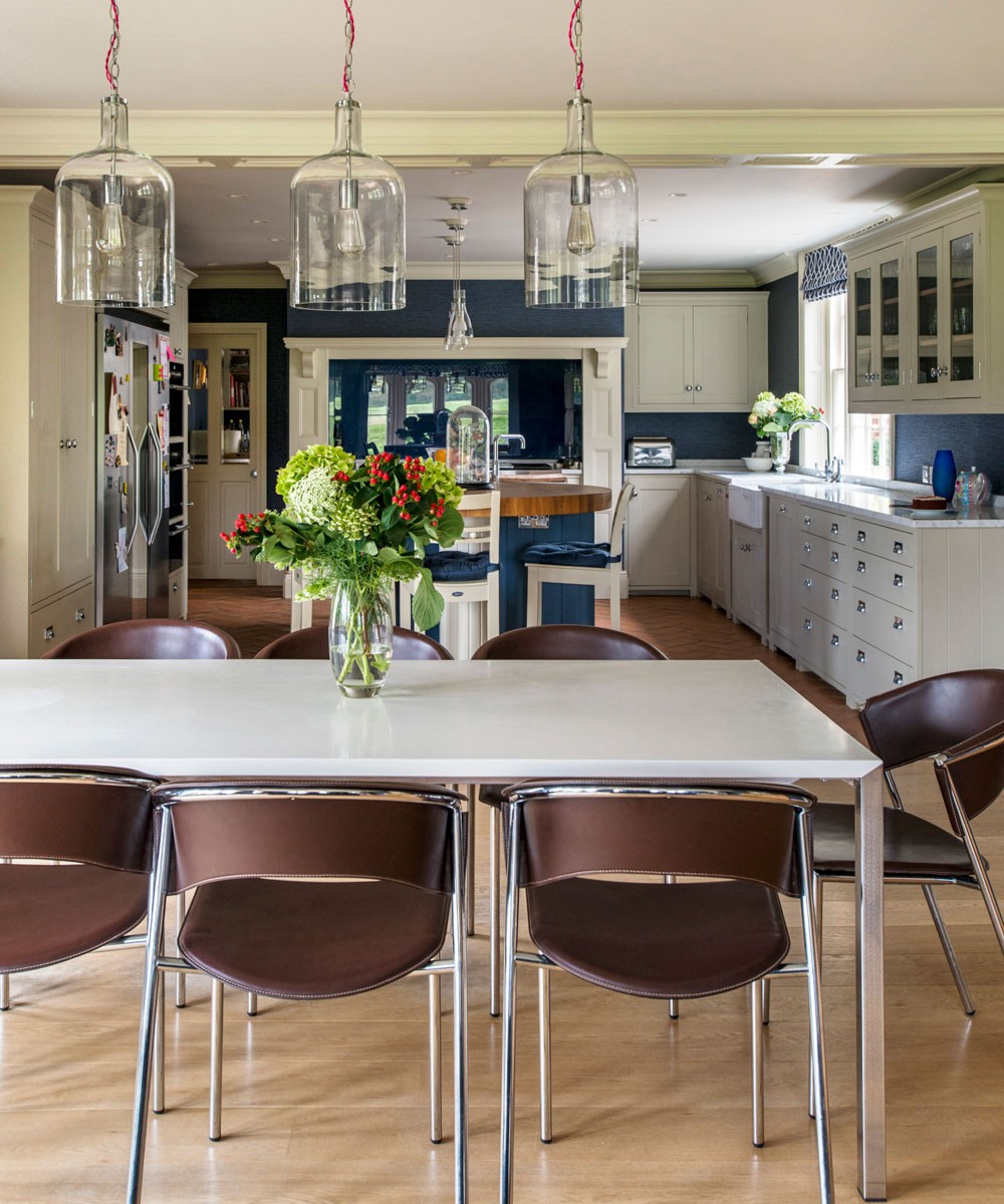 blue kitchen with dining table and lamps