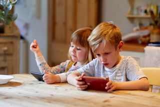 Children playing together on an ipad