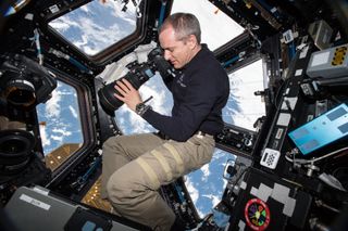 Astronaut David Saint-Jacques of the Canadian Space Agency takes pictures of the Earth below from inside the International Space Station's Cupola observatory, on Jan. 15, 2019.