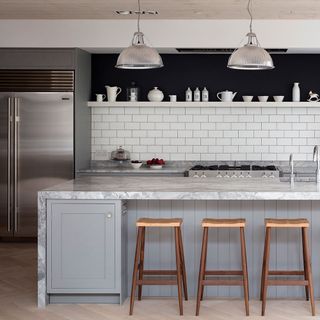 kitchen with marble countertop and wooden stools