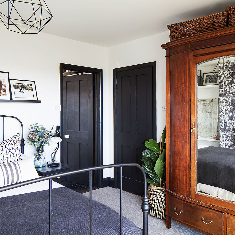 bedroom with wooden cupboard and table lamp