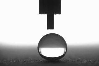 A water droplet resting on a superhydrophobic surface has a contact angle of at least 150 degrees.