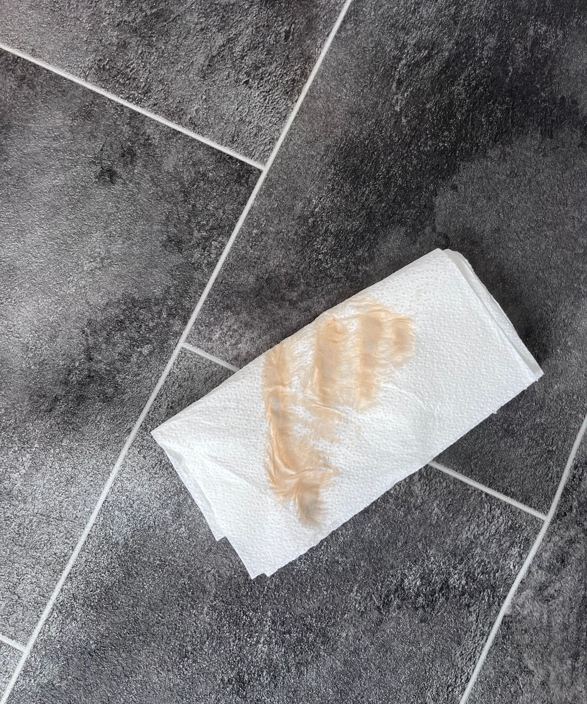 A paper towel with ketchup smears