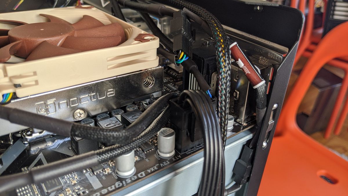 I plugged both rear fans into a Noctua splitter, which I jammed into the space around the I/O shield to keep it out of the way.