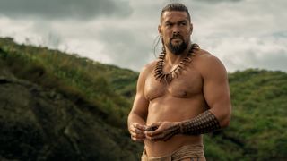 Shirtless Jason Momoa stands in the open in a scene from Apple TV Plus' "Chief of War"