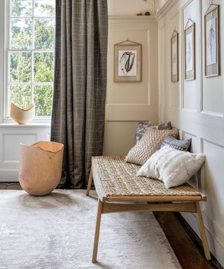 Modern entryway bench ideas with rattan bench, neutral cushions and grey curtain
