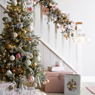 Christmas tree and christmas decor on white staircase