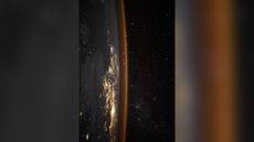 The sideways Earth glimmers in this photo taken from the International Space Station